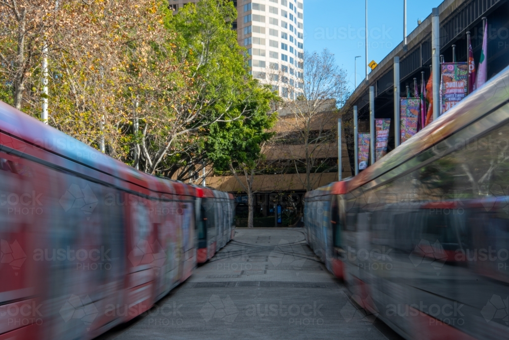 Two light rail trains in Sydney at Circular Quay shot with a long exposure - Australian Stock Image