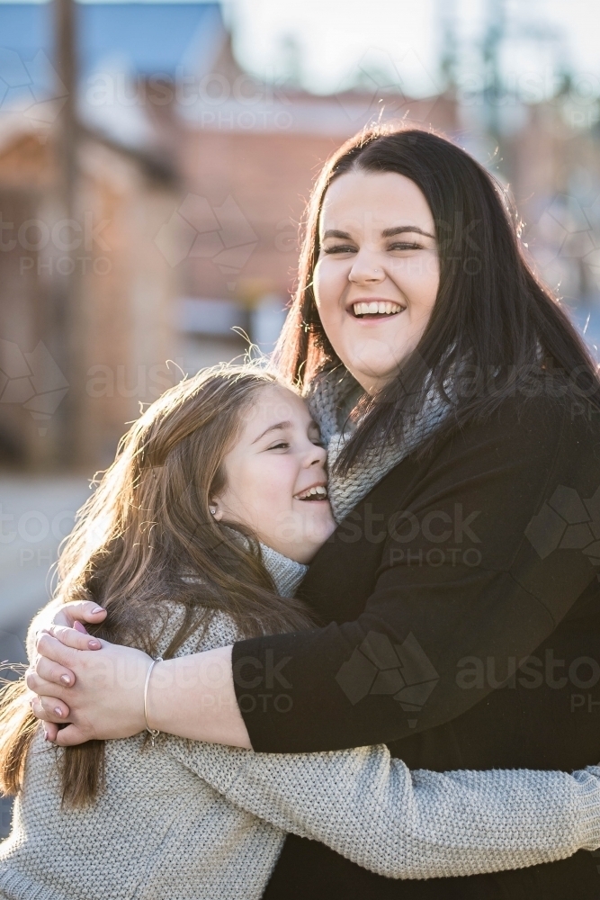 Image Of Two Sisters Hugging And Laughing Austockphoto 9958