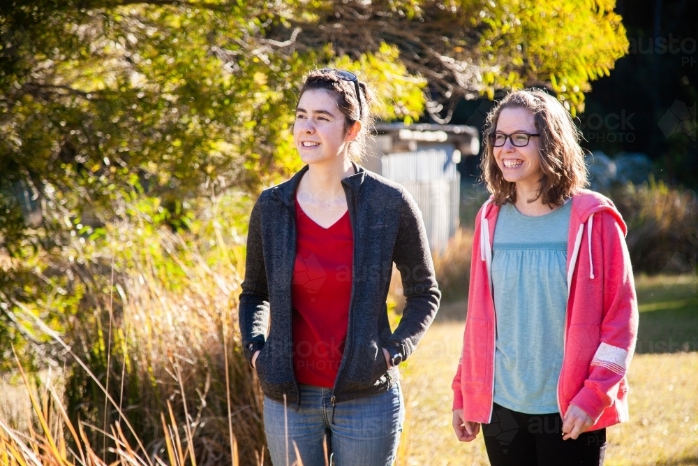 Two teen friends standing together outside in winter - Australian Stock Image