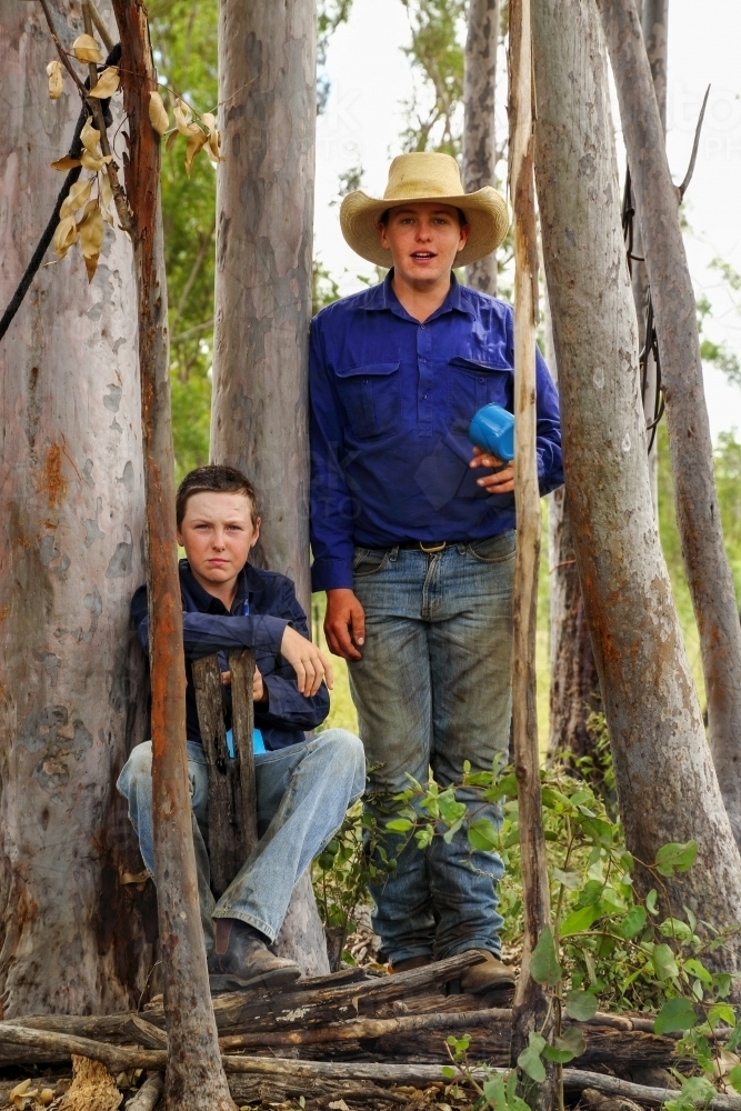 Two teenage boys looking at camera on a farm. - Australian Stock Image