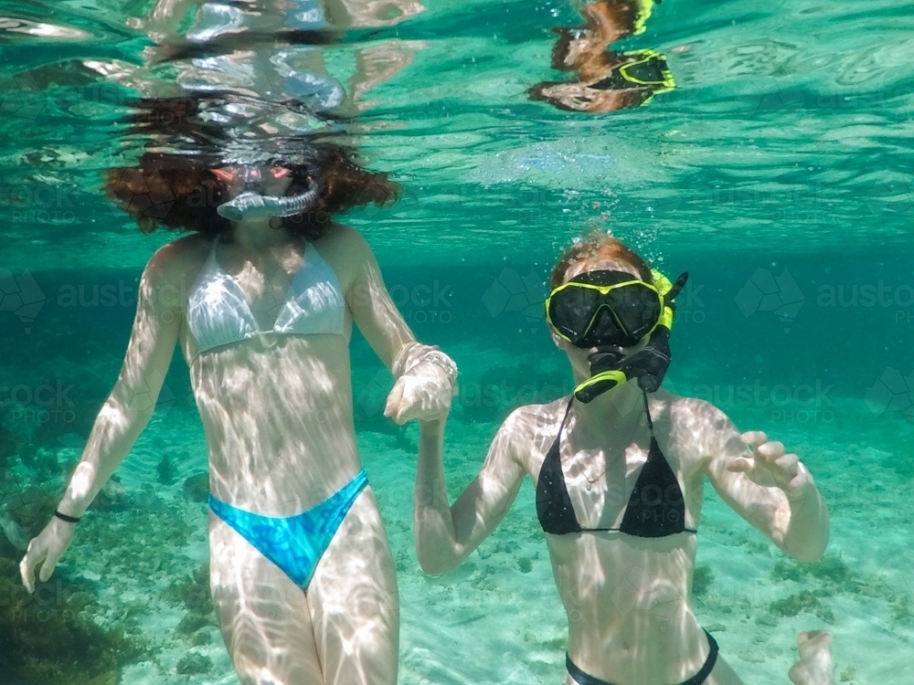 Two teenage girls snorkelling in an ocean rock pool - Australian Stock Image