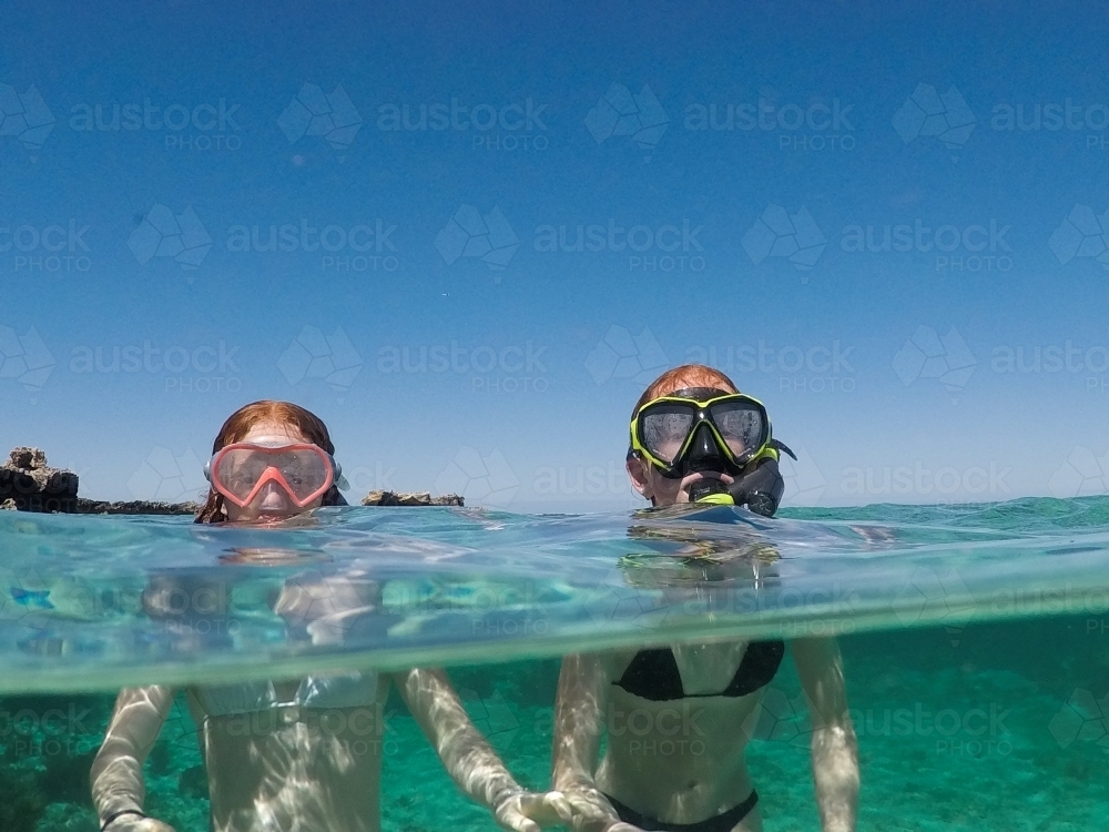 Two teenage girls snorkelling in the ocean - Australian Stock Image
