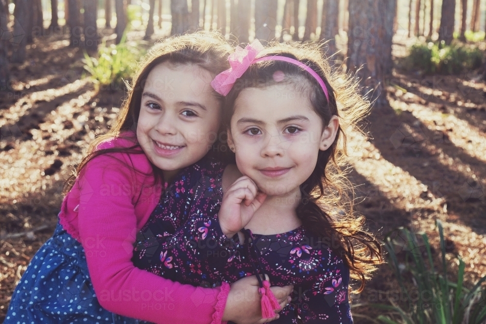 Two young multicultural girls in the wood - Australian Stock Image