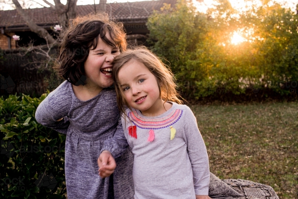 Two young sisters holding hands - Australian Stock Image