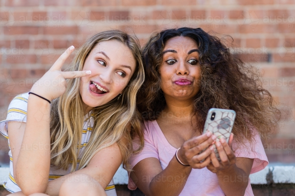 two young women making selfies - Australian Stock Image