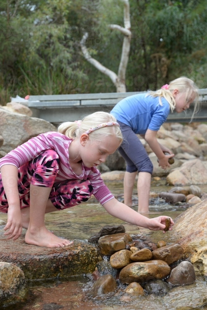 Two Youngs Girls Playing in a Stream - Australian Stock Image