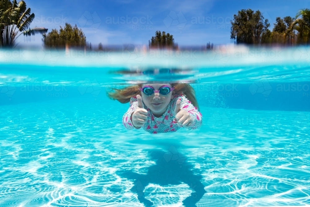 Under water shot of young girl swimming - Australian Stock Image