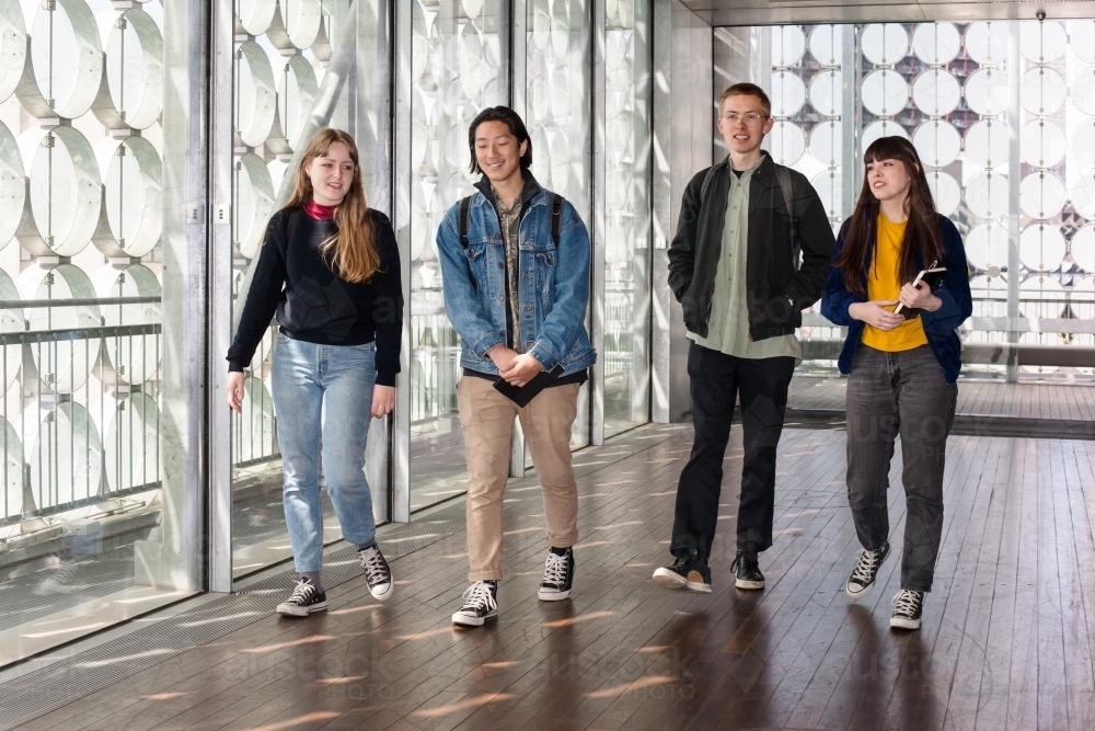 university students walking through building on campus - Australian Stock Image