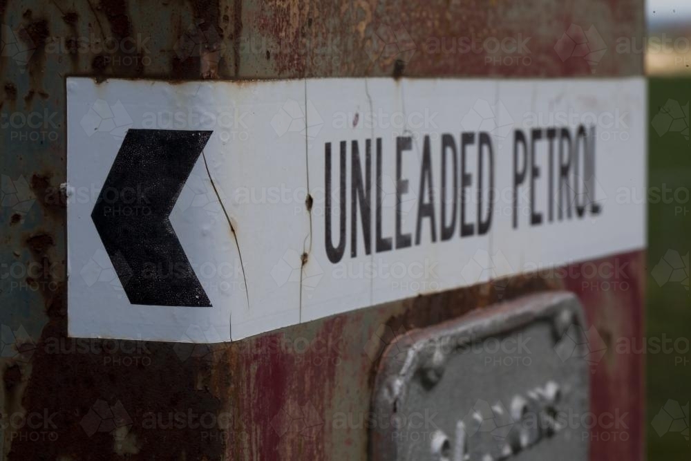 Unleaded petrol sign on vintage petrol bowser found on a farm - Australian Stock Image