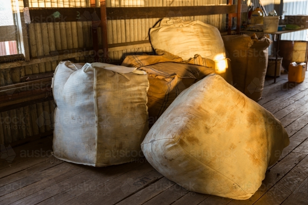 Unpressed merino wool bales in shearing shed - Australian Stock Image