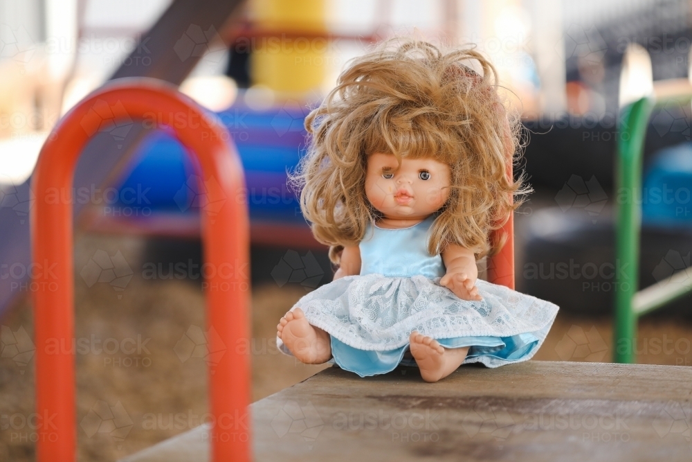 Unruly female doll with messy hair in preschool yard - Australian Stock Image