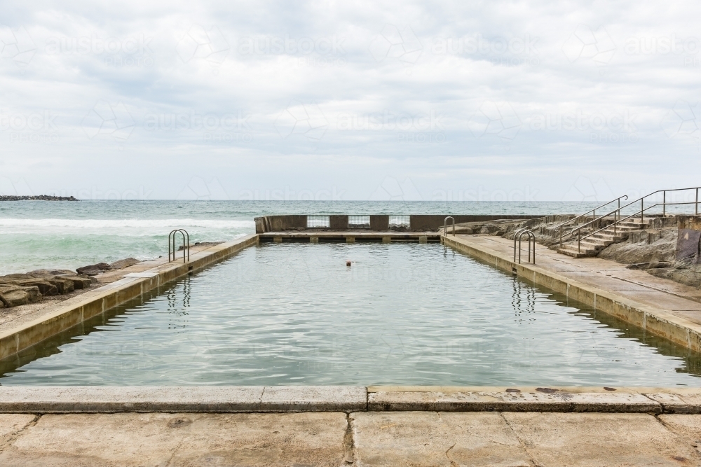 Up close view of woman swimming in ocean pool at beach - Australian Stock Image