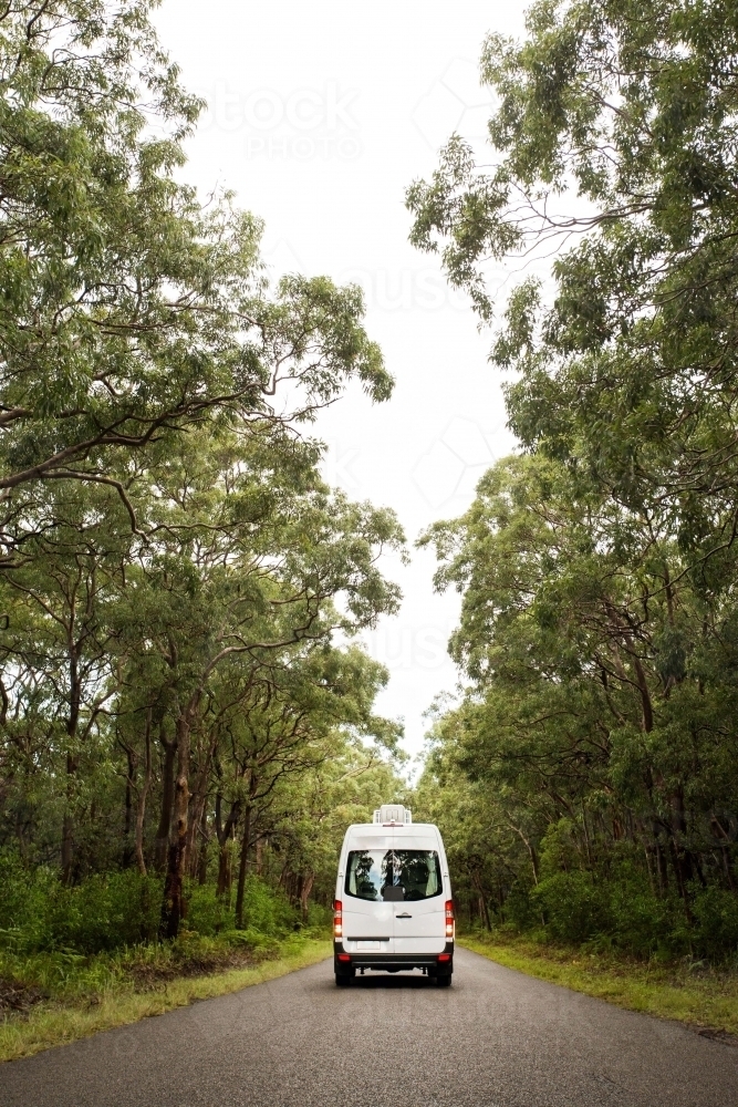 Van driving down bushland road - Australian Stock Image