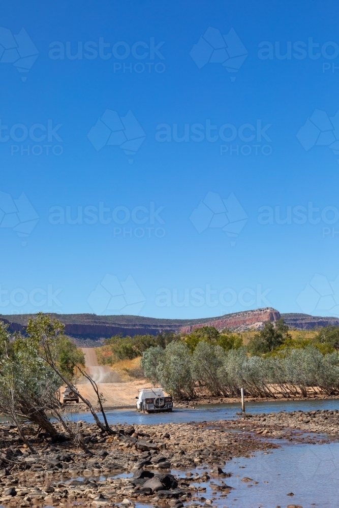 vehicle crossing Pentecost River on the Gibb River Road in the Kimberley - Australian Stock Image