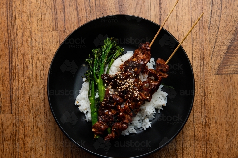 Venison / Beef Bbq skewers on rice with broccolini - Australian Stock Image