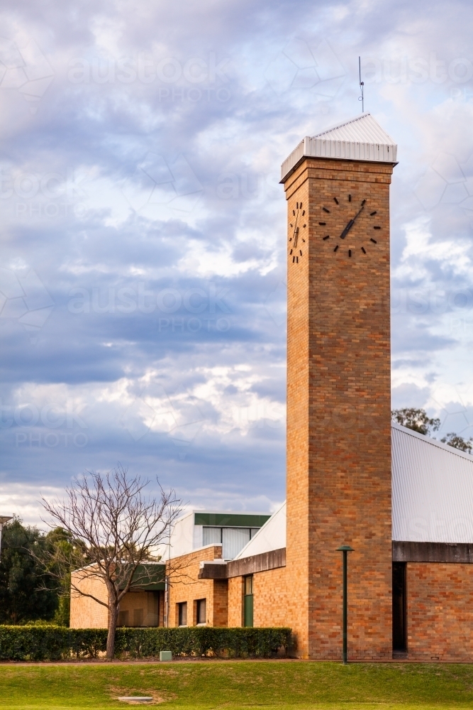 Vertical image of brick clock tower in last light of day in Singleton - Australian Stock Image