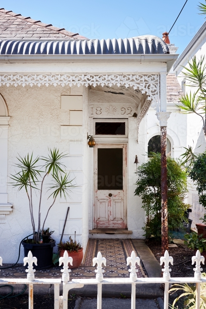 Vertical shot of a small white side door - Australian Stock Image