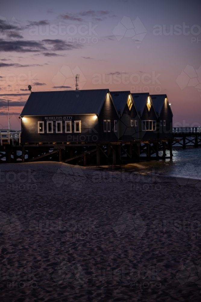 vertical shot of beach buildings with walkway under cloudy sunset skies - Australian Stock Image