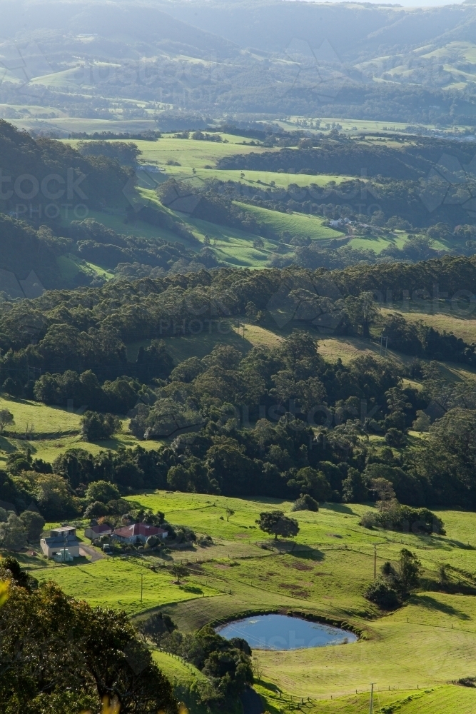 Vertical view of dam and farm with green paddocks - Australian Stock Image