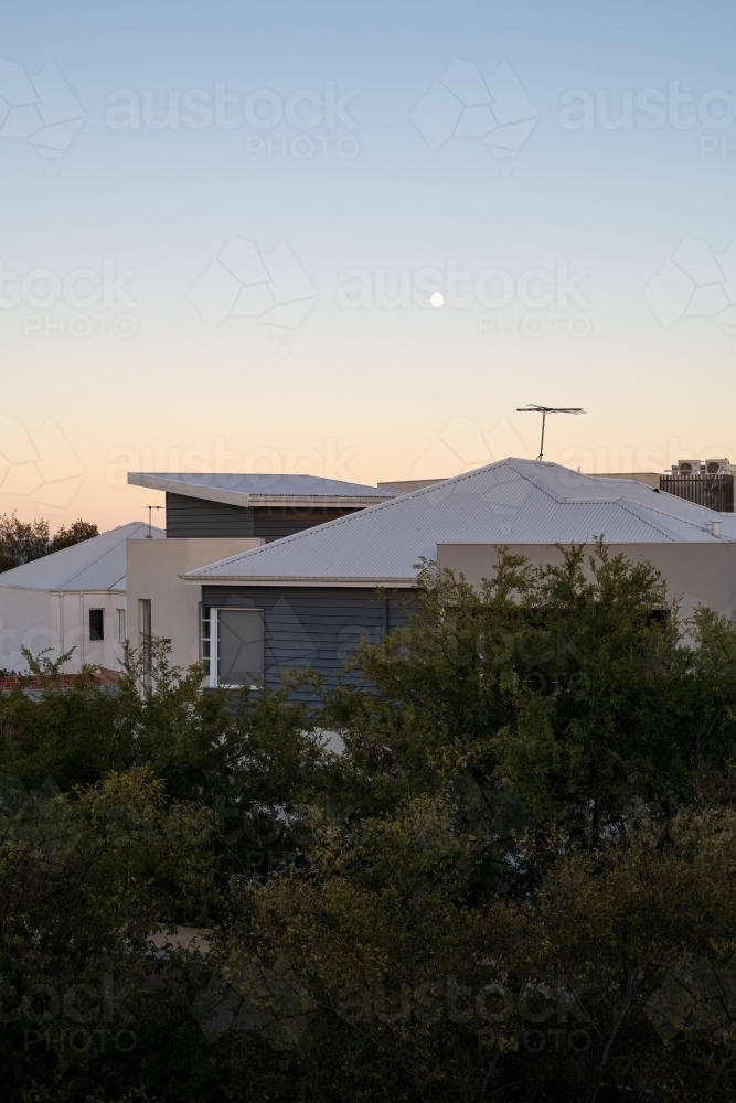 Vertical view of sunset over roof tops - Australian Stock Image