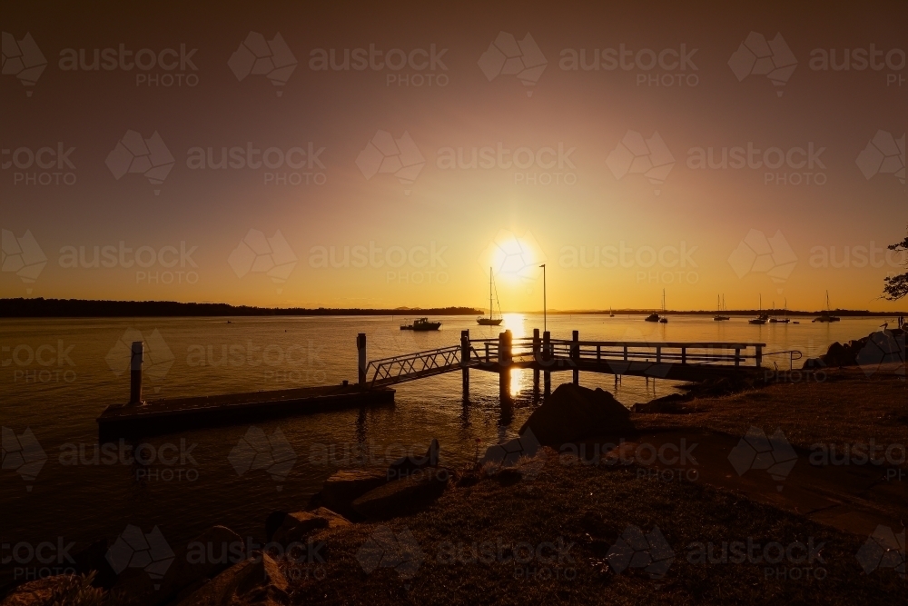 Vibrant afternoon sunset over jetty at Iluka in NSW Australia - Australian Stock Image