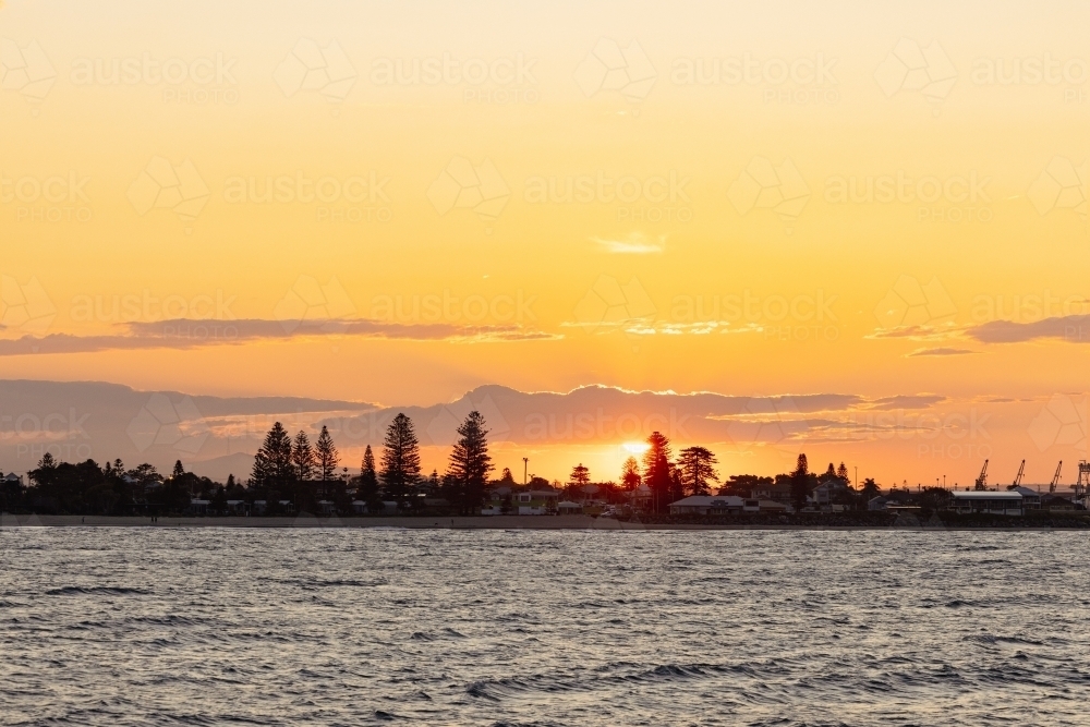 Vibrant orange sunset over Stockton NSW - Australian Stock Image