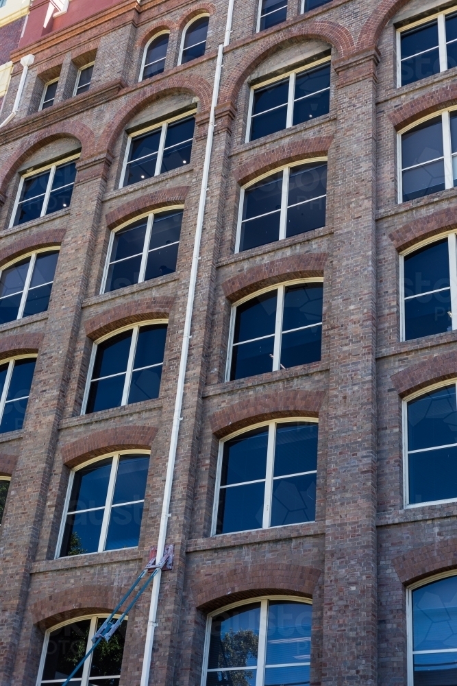 Victorian warehouse architecture with brick and white window framing - Australian Stock Image