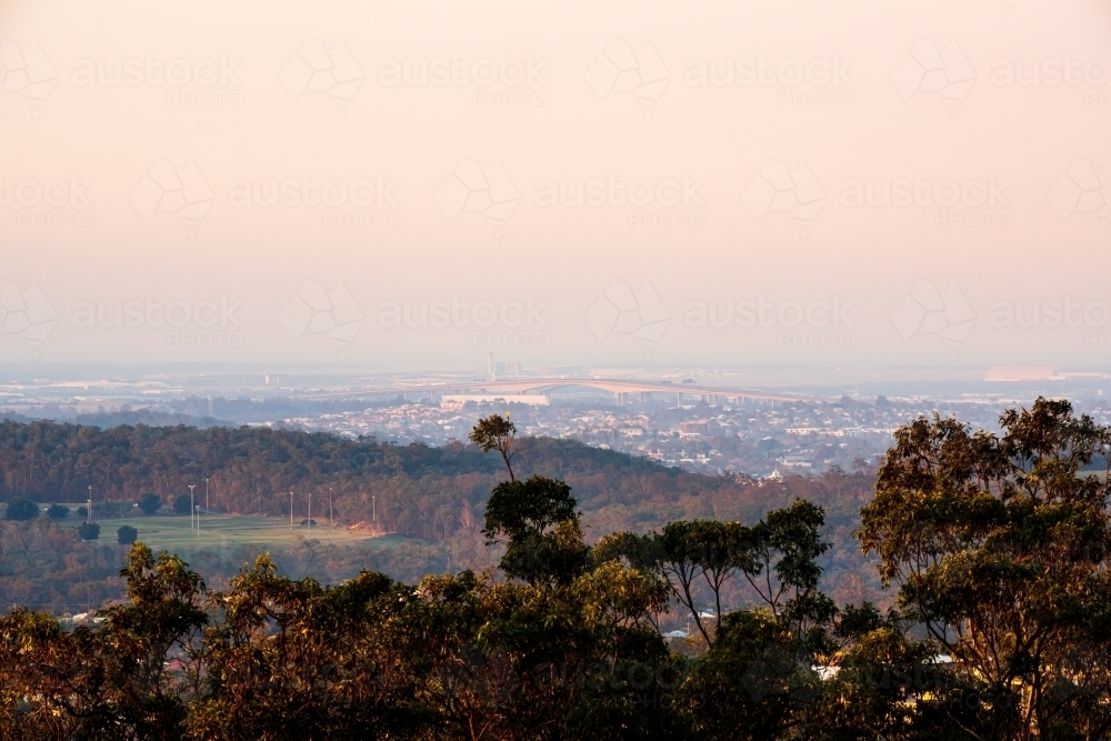 View of across Brisbane  suburbs to Gateway Bridge in the smoke haze - Australian Stock Image
