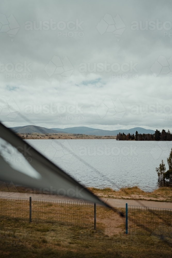 View of Lake Jindabyne while camping on overcast day - Australian Stock Image