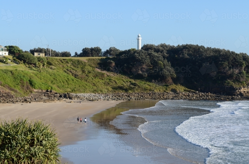 View of Main Beach, Yamba, with family walking along beach - Australian Stock Image