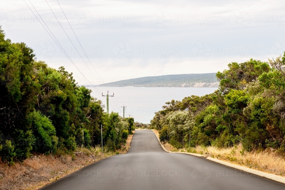 View of road leading down to the ocean - Australian Stock Image