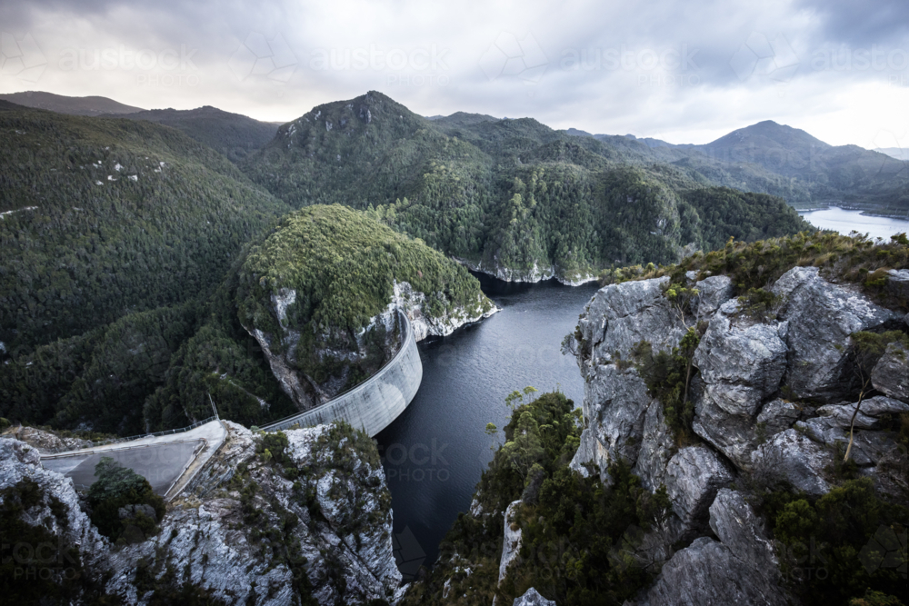 View of the Gordon Dam on a cool summer's day. It is a unique double curvature concrete arch dam - Australian Stock Image