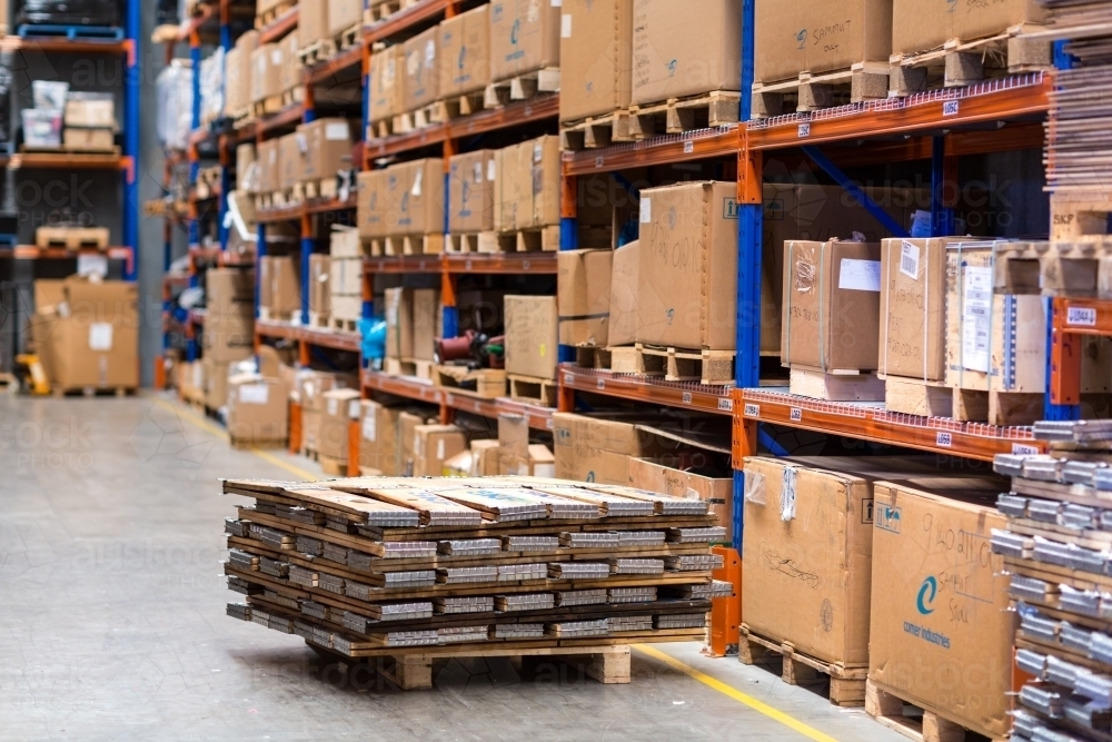 Warehouse interior with boxes stacked on shelves - Australian Stock Image