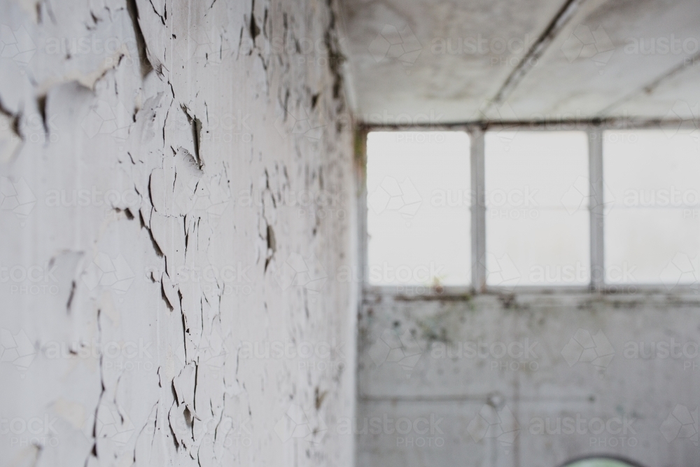 warehouse window in derelict apartment lobby - Australian Stock Image