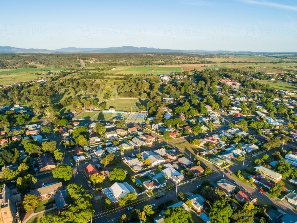 warm summer sunset light over town with distant farmland - Australian Stock Image