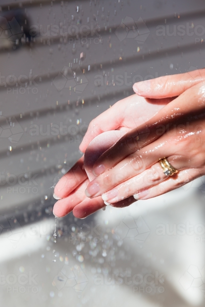 Washing hands in the gentle morning light - Australian Stock Image