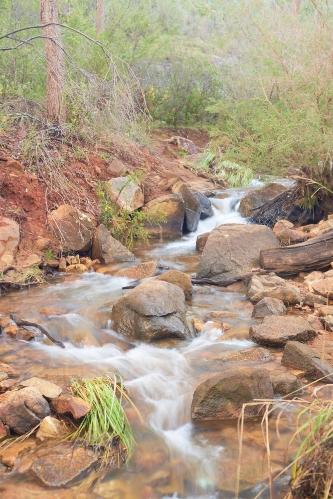 Water cascading down rocky stream near Lesmurdie Falls, Perth, Western Australia. - Australian Stock Image