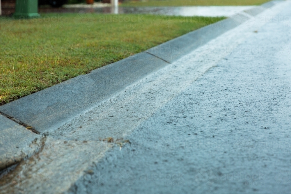 water flowing down a gutter - Australian Stock Image