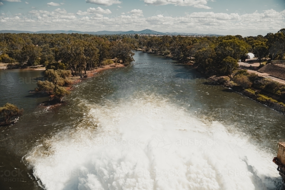 Water flowing from the Hume Dam wall into the Murray River towards Albury. - Australian Stock Image