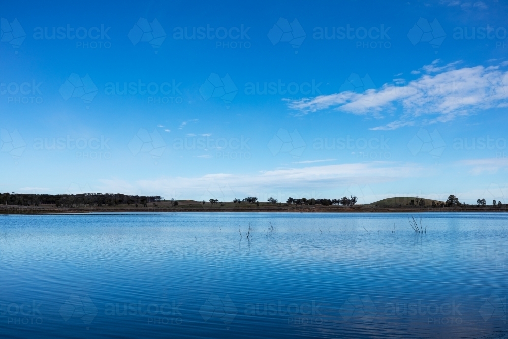 water in reservoir under blue sky - Australian Stock Image