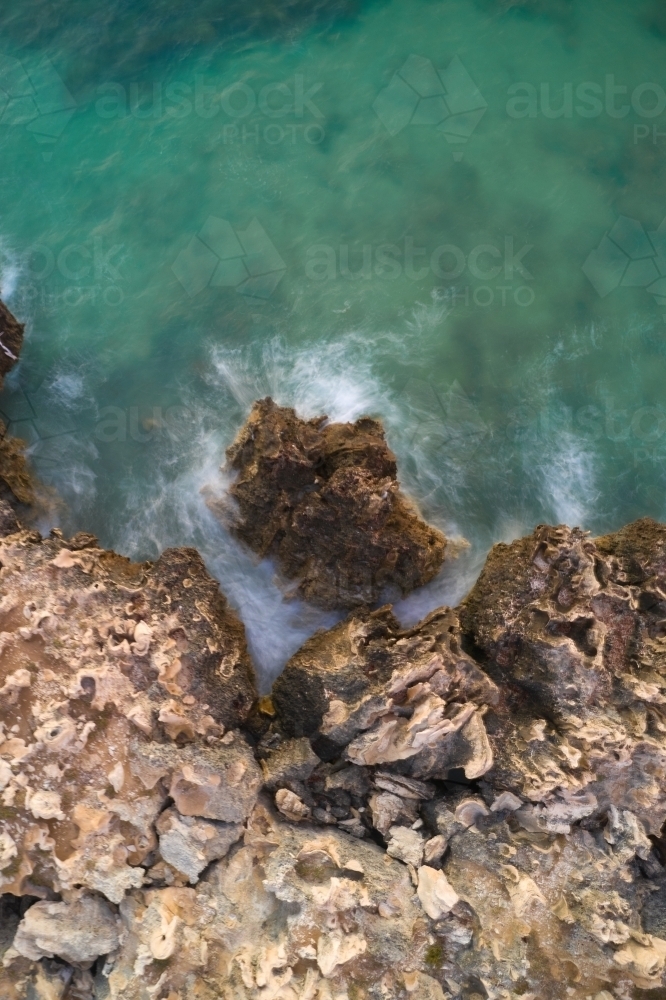 Wave on limestone cliff long exposure from above, at the Henderson Cliffs. - Australian Stock Image