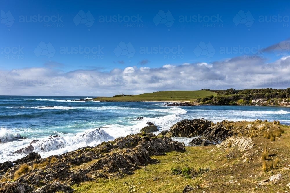 Waves crash into the dramatic King Island shoreline - Australian Stock Image