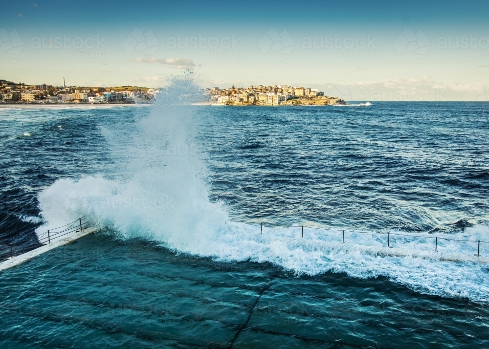 Waves crashing against empty ocean pool - Australian Stock Image