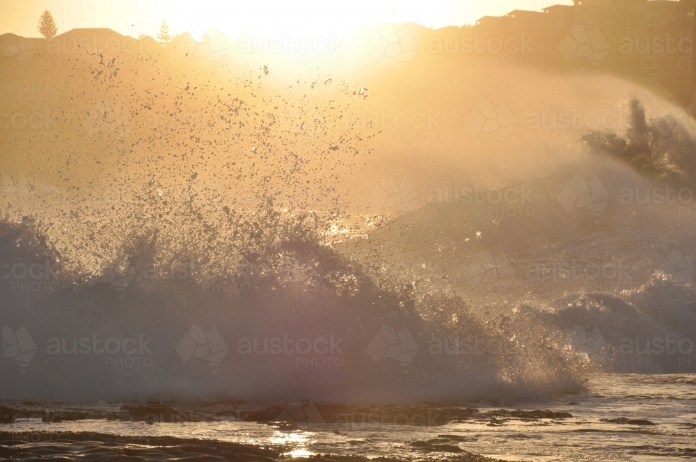 Waves crashing with sun - Australian Stock Image