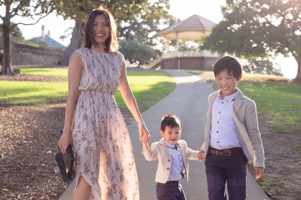 well-dressed mum with her two sons at the park - Australian Stock Image