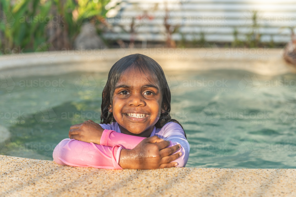 Wet 3 year old aboriginal girl in the pool - Australian Stock Image