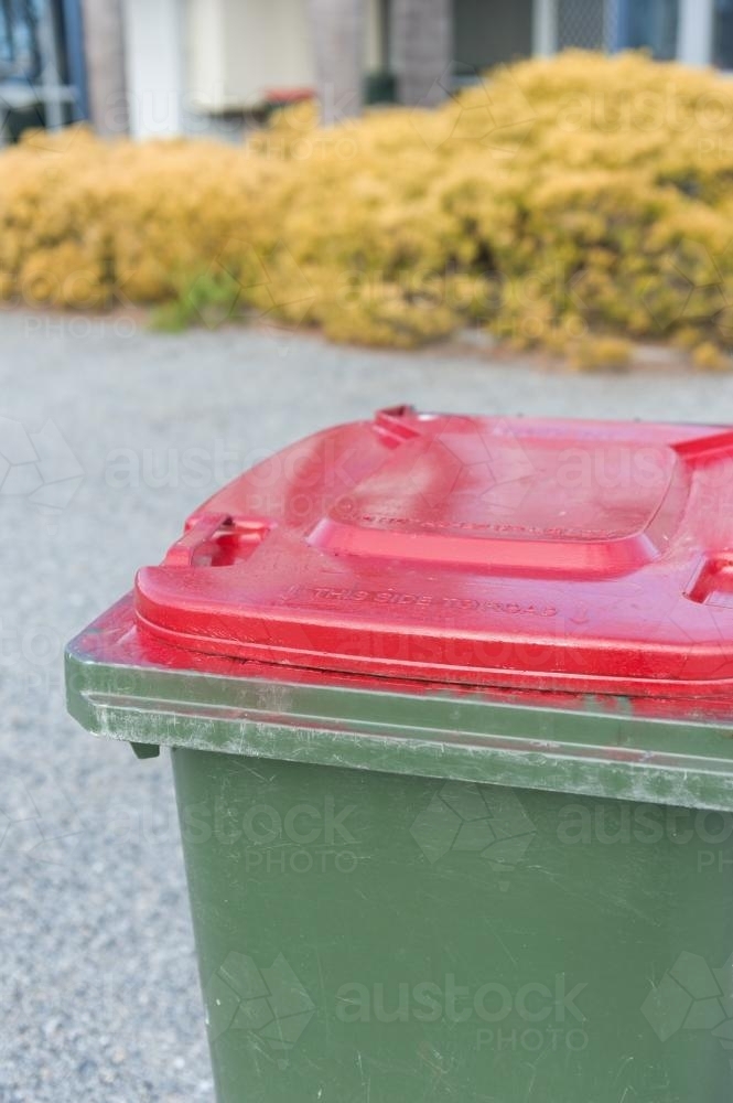 Image of wheelie bin with red lid - Austockphoto