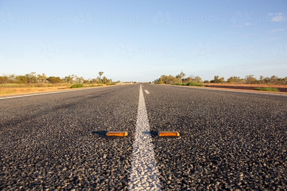 White line and cats-eye reflectors on an outback highway - Australian Stock Image