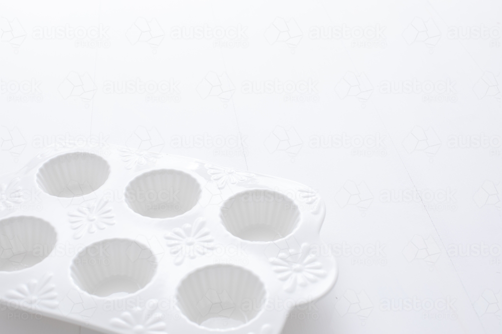 White muffin tray on blank background - Australian Stock Image