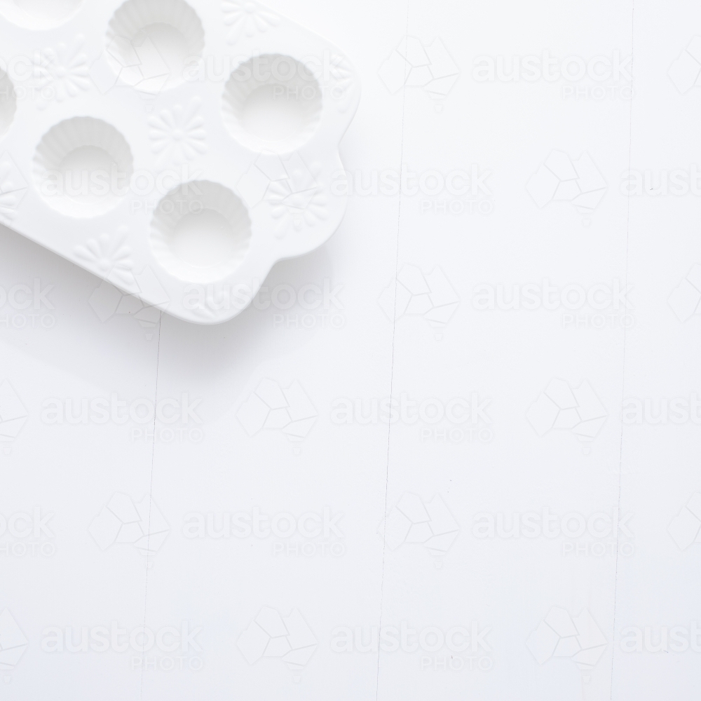 White muffin tray on blank background - Australian Stock Image